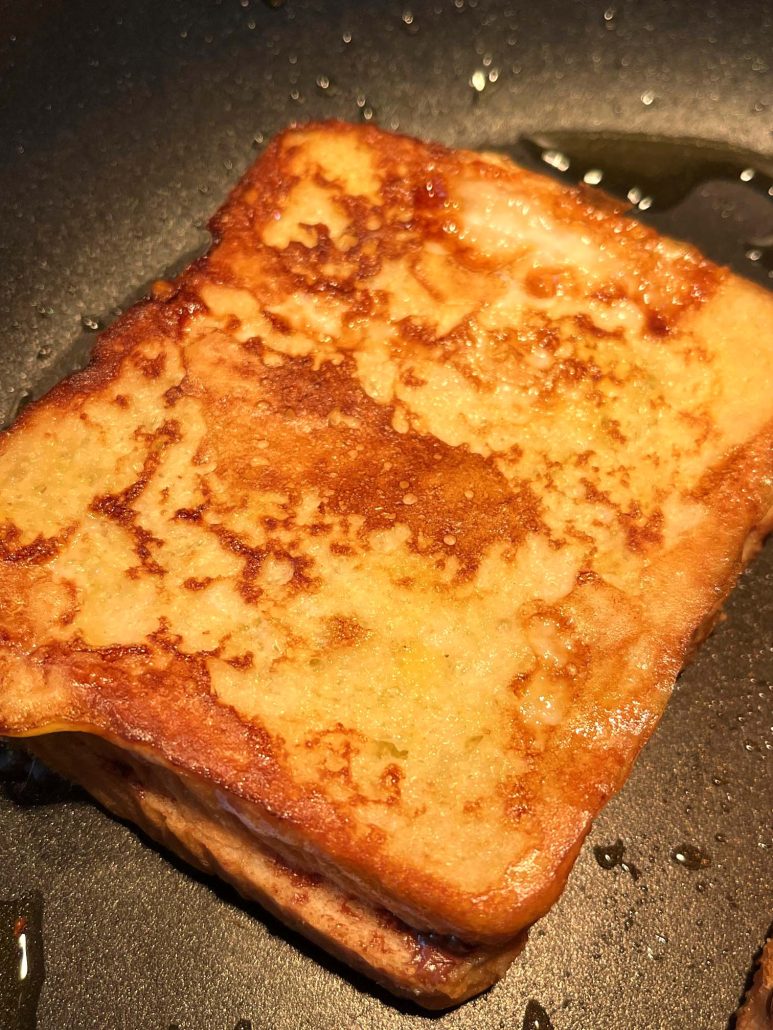 Nutella Stuffed French Toast cooking up golden brown