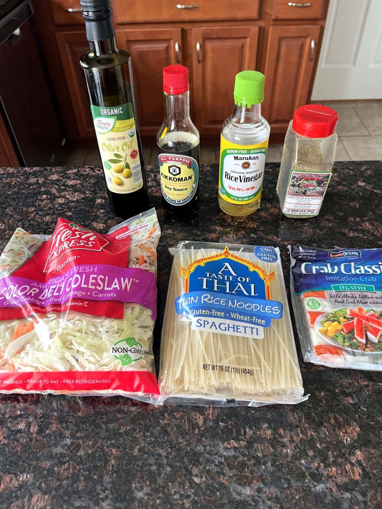 ingredients for Spring Roll In A Bowl: coleslaw mix, rice noodles, imitation crab, olive oil, soy sauce, rice vinegar, and pepper