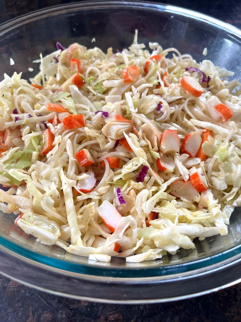 toss together rice noodles, coleslaw mix, crab, and dressing