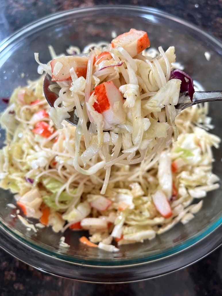 spring roll in a bowl being toss with homemade dressing