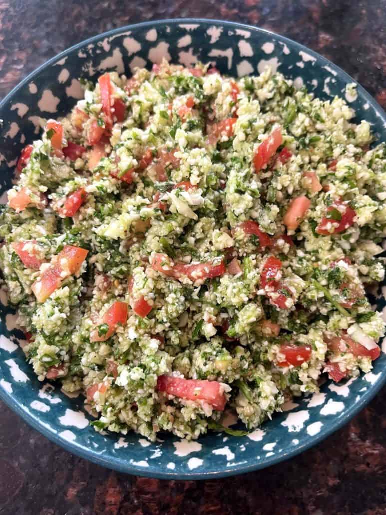 Cauliflower tabbouleh salad with finely chopped cauliflower, parsley, tomatoes, and cucumbers, tossed in a lemon dressing