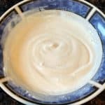 Top view of a finished dip made with Greek yogurt, smooth and creamy in texture, served in a bowl.