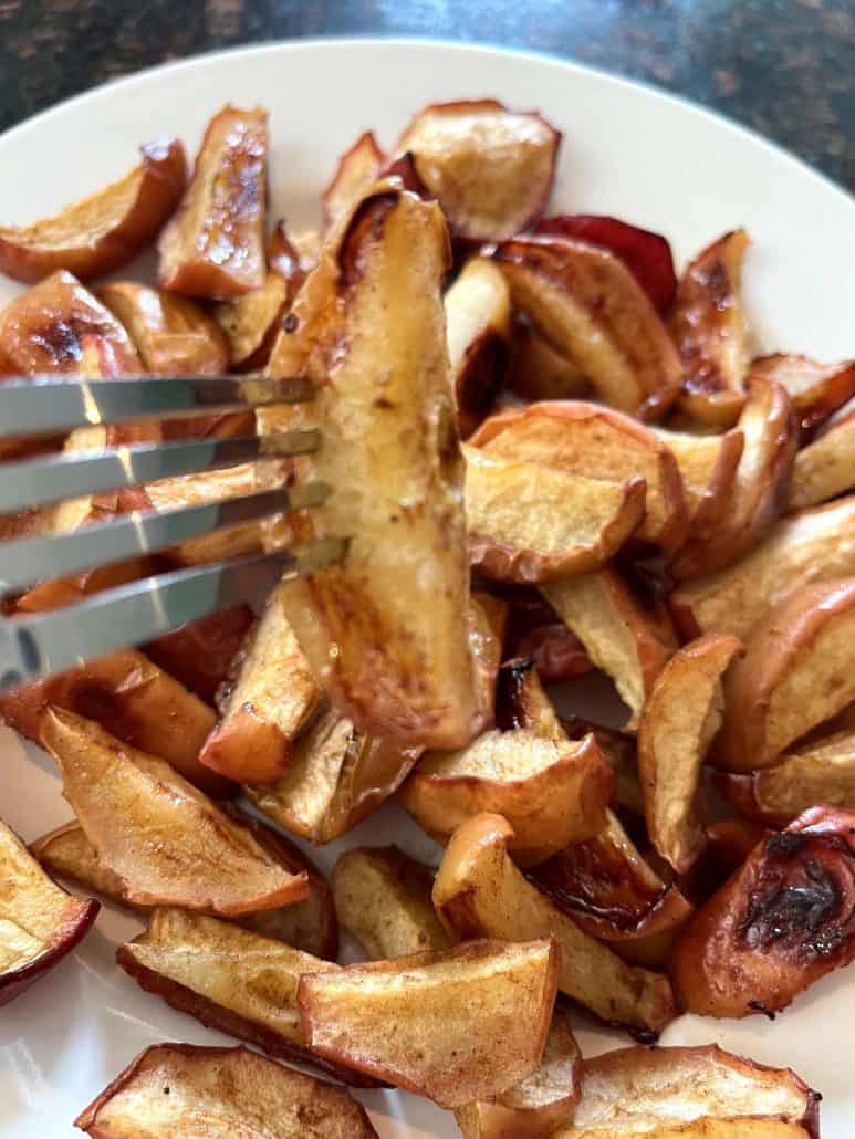 Close-up of perfectly roasted apples with a crispy, caramelized exterior and soft, juicy centers.