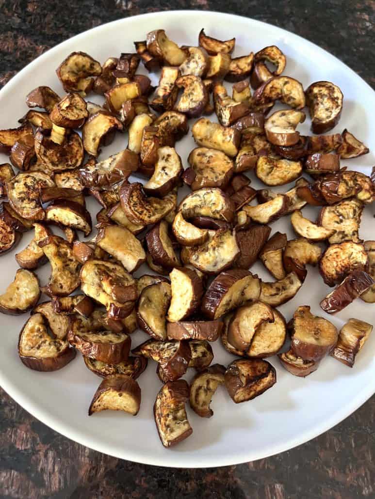 A plate of crispy, roasted Chinese eggplant chunks, freshly cooked in the air fryer and ready to serve as a tasty side dish or snack.