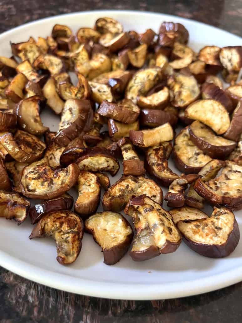 A plate filled with crispy air-fried Chinese eggplant pieces, perfectly roasted and ready to enjoy as a healthy and flavorful side dish.