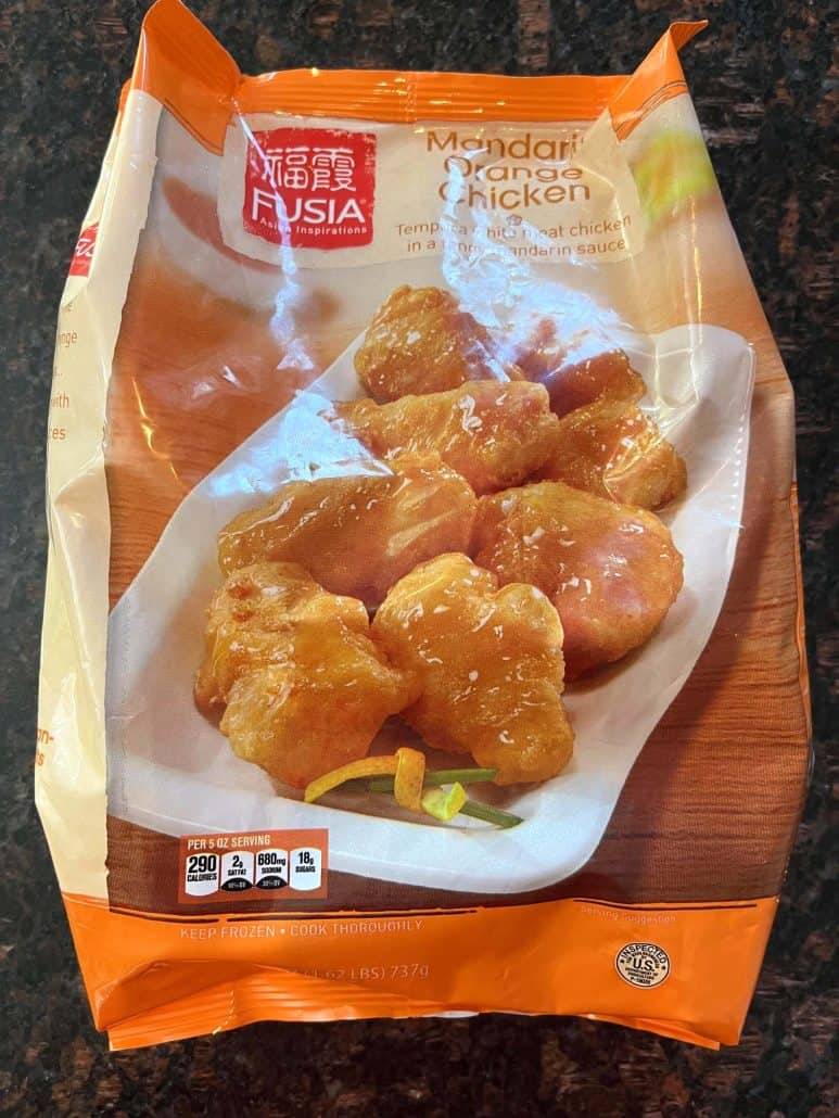 A package of Aldi's Fusia Mandarin Orange Chicken, showing the frozen product used in the air fryer recipe for crispy orange chicken with sweet and tangy sauce.