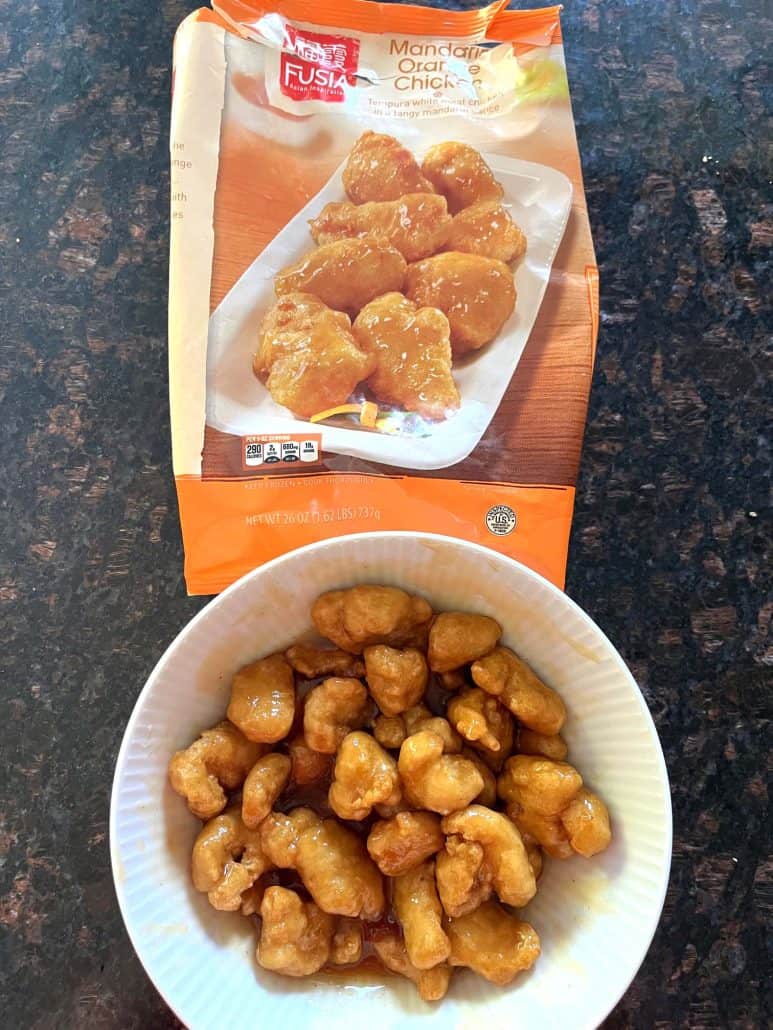 A bowl of air-fried Fusia Mandarin Orange Chicken from Aldi, showing the finished crispy and saucy dish.