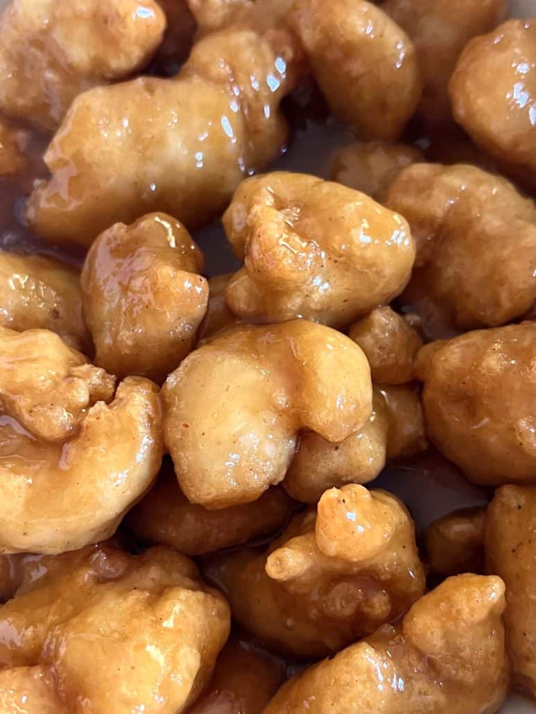 Close-up of crispy air-fried Fusia Mandarin Orange Chicken, highlighting the golden coating and glossy orange sauce