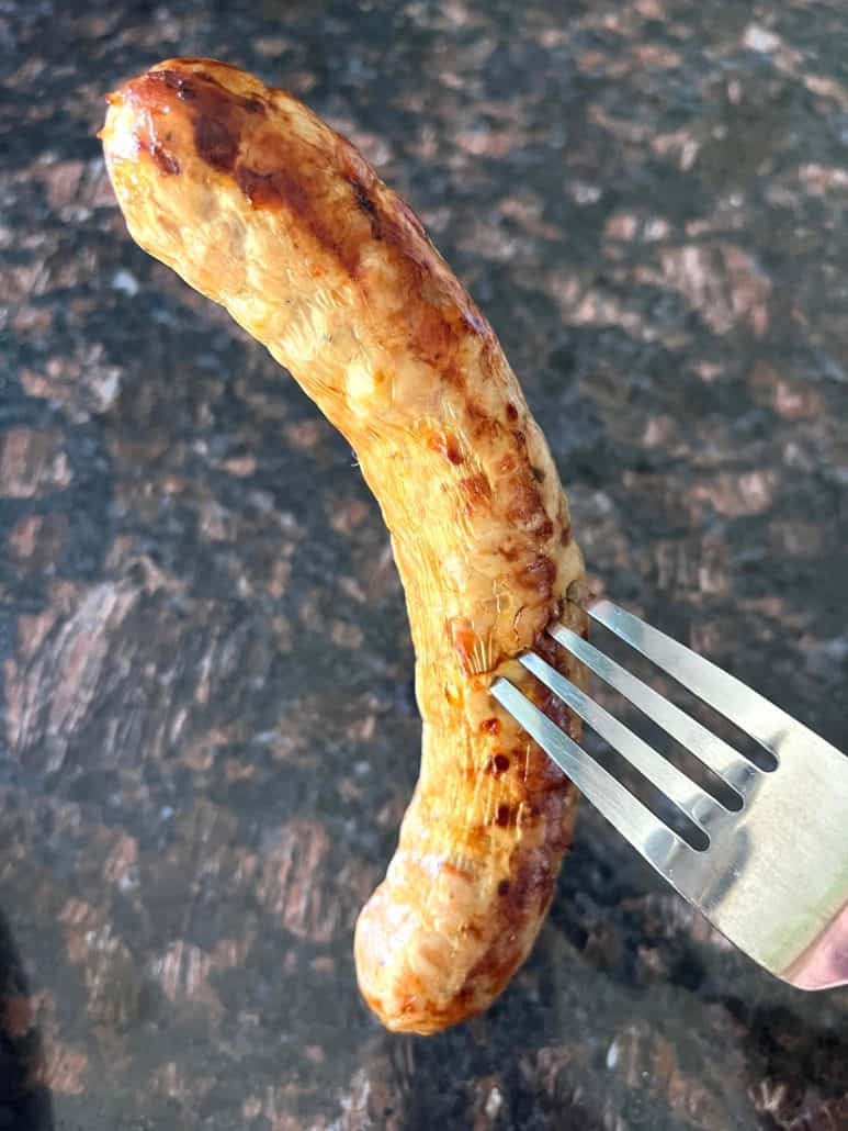 Greek sausage on a fork.