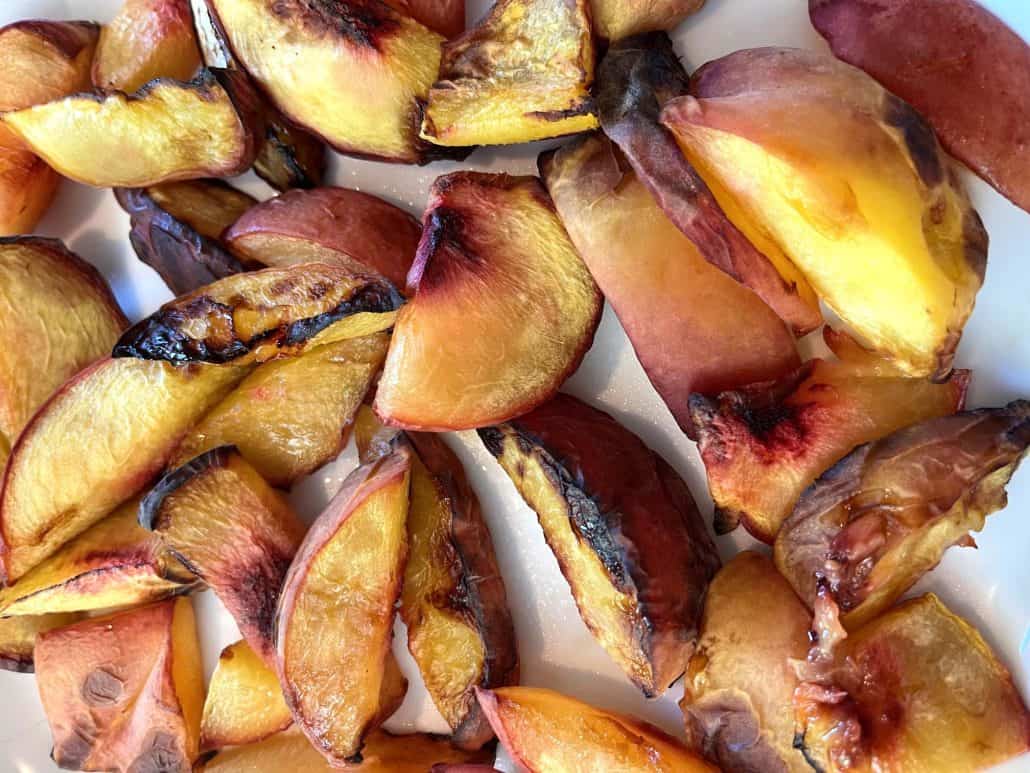 Close-up of roasted peach slices on a plate. Perfect as a healthy snack or dessert.