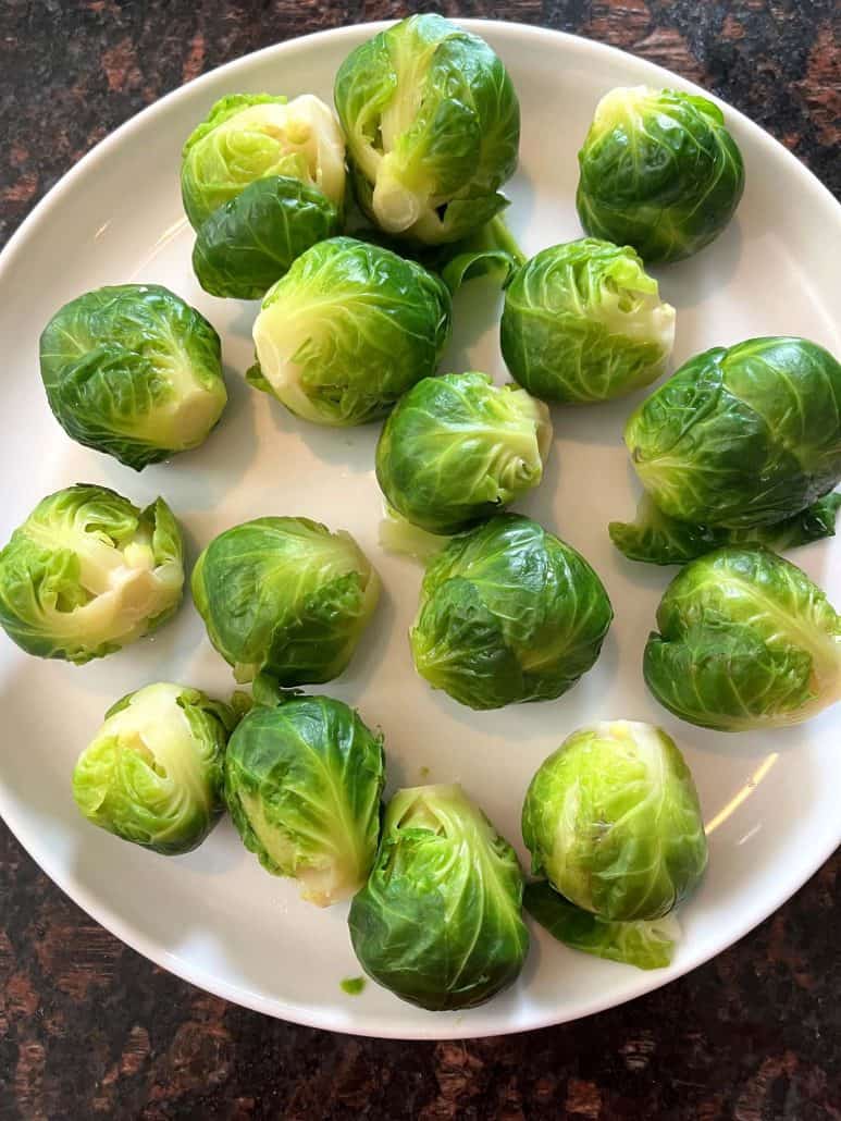 A plate of perfectly boiled Brussels sprouts,.