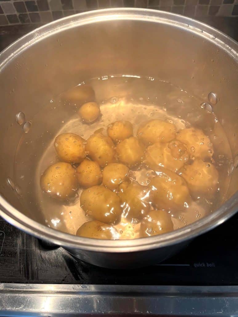 Small potatoes actively boiling in a hot pot for several minutes