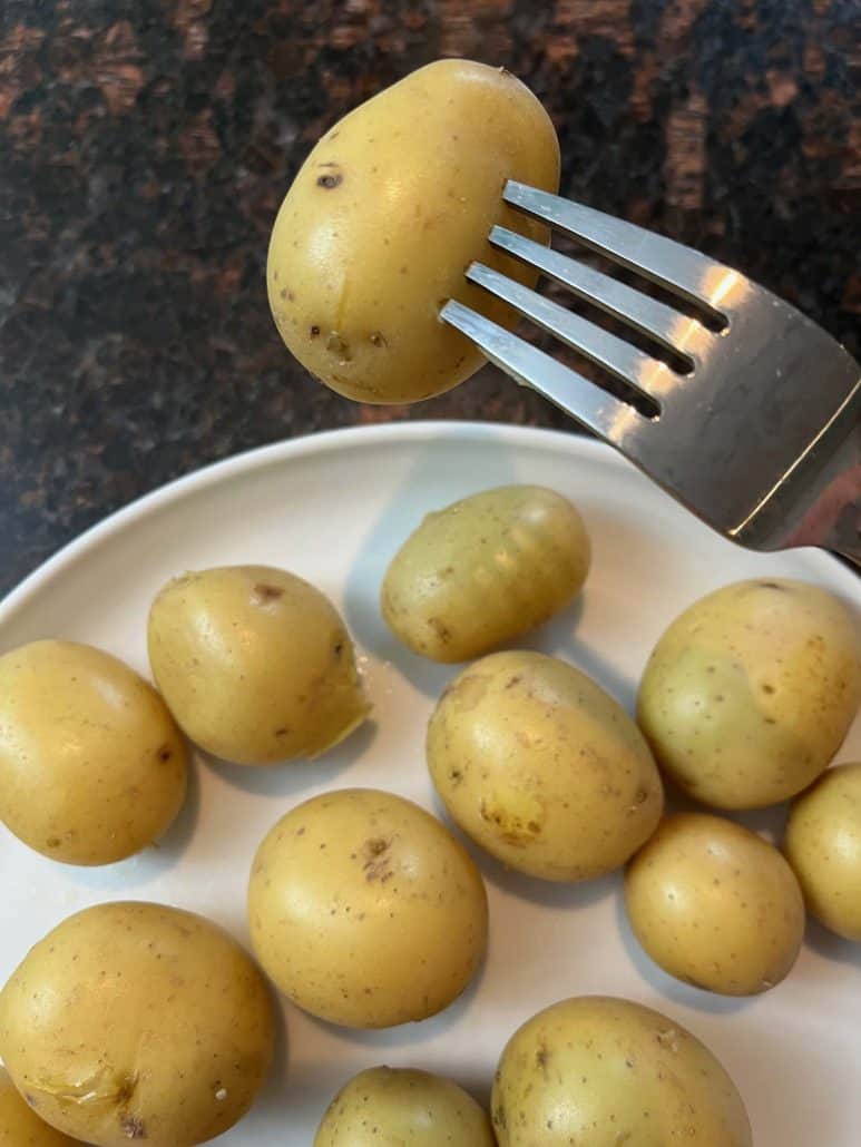 Closed-up boiled small potatoes showing their tender texture.