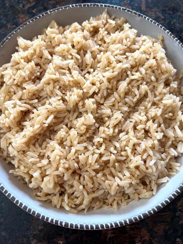 A close-up view of a bowl filled with perfectly cooked bone broth rice, showcasing the fluffy texture and separate grains.