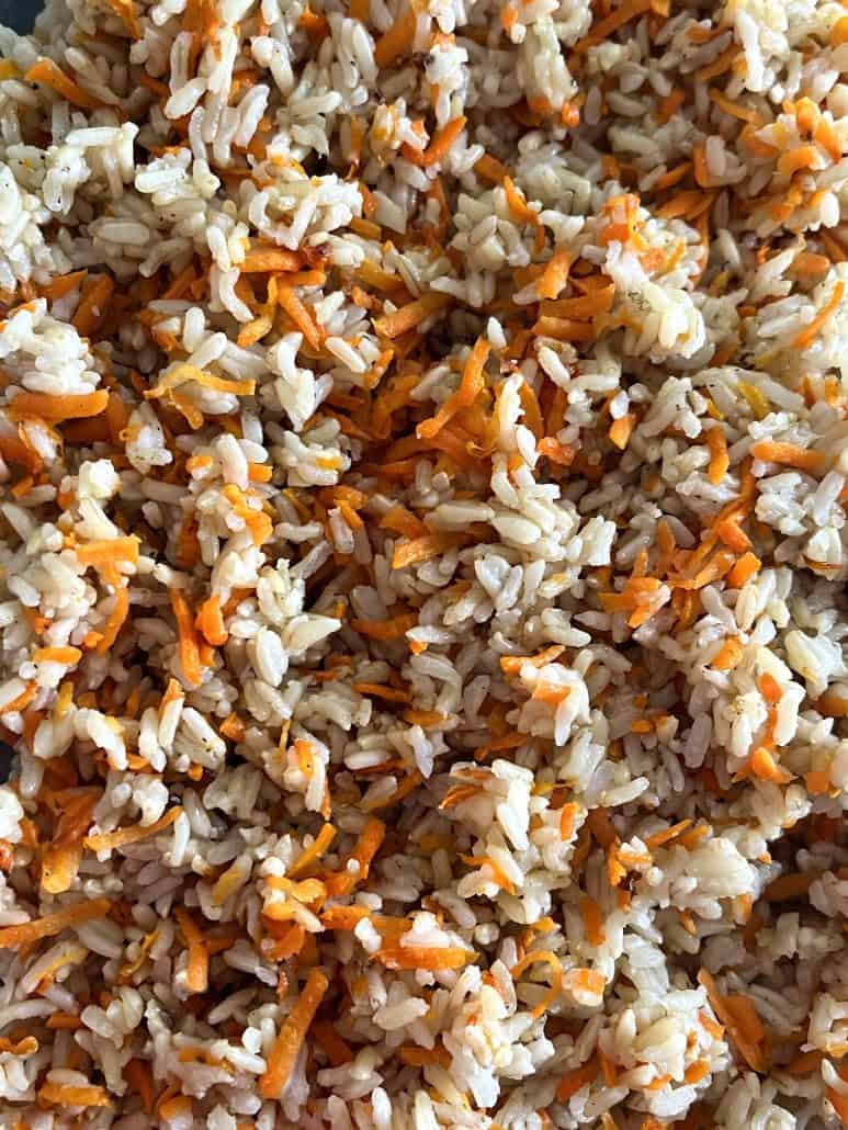 A close-up view of Carrot Rice, highlighting the fluffy rice grains mixed with vibrant shredded carrots for a healthy and colorful dish.