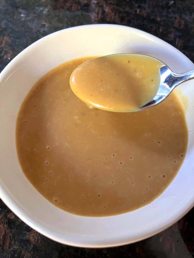 A close-up of a spoonful of creamy homemade Chick-Fil-A sauce.