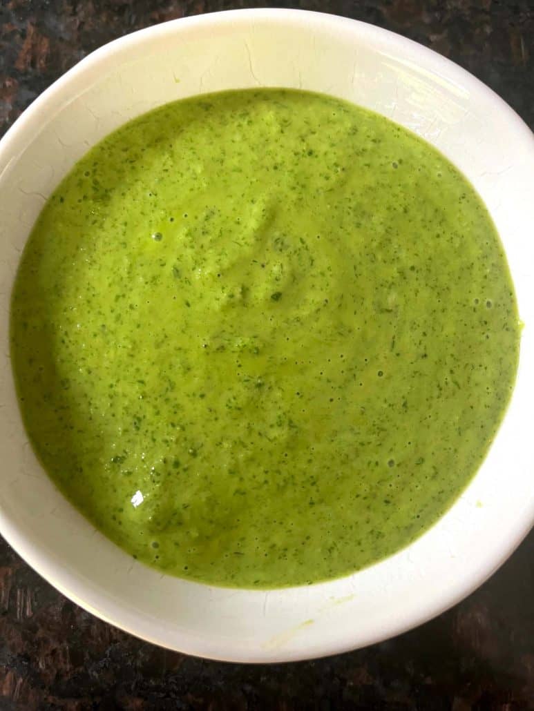 Overhead shot of a bowl filled with vibrant green Cilantro Chimichurri sauce.