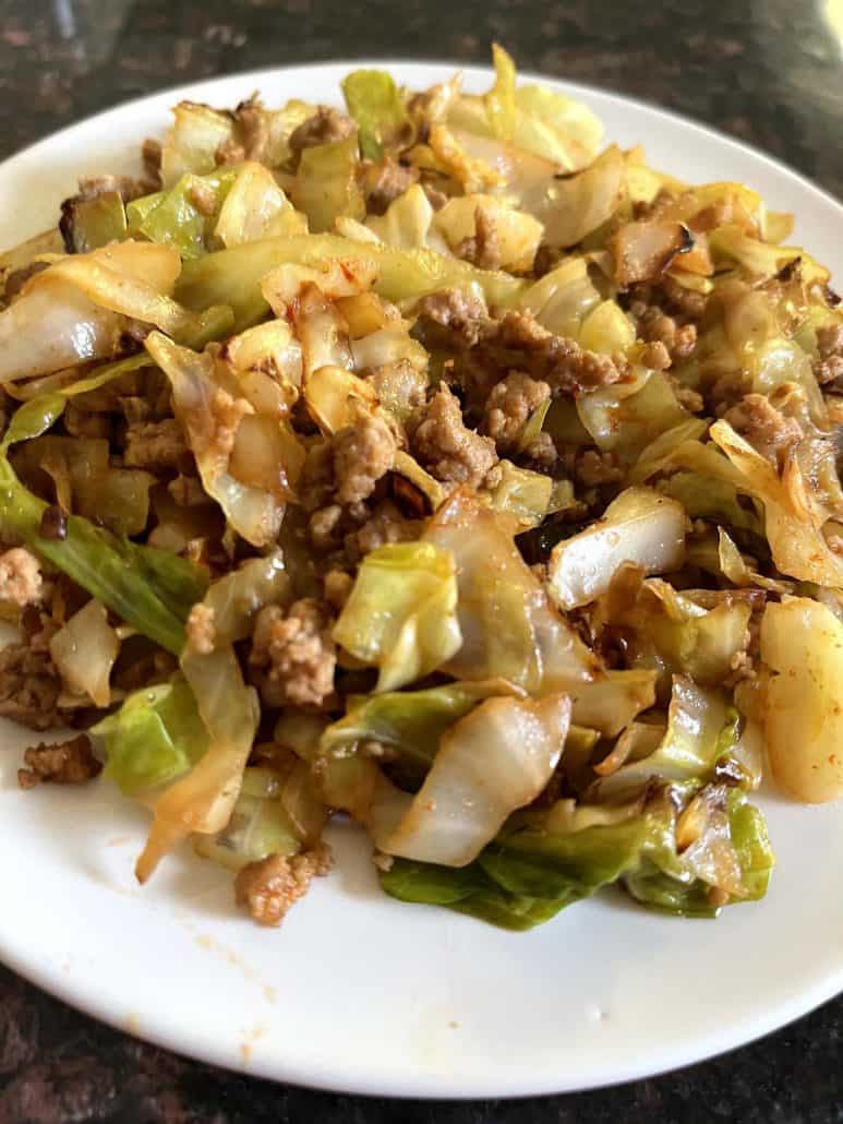 Close-up of a plate filled with ground turkey and sautéed cabbage.