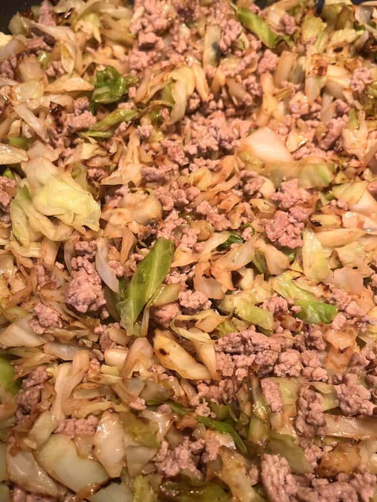 Close-up of cooked ground turkey and sautéed cabbage mixed together.