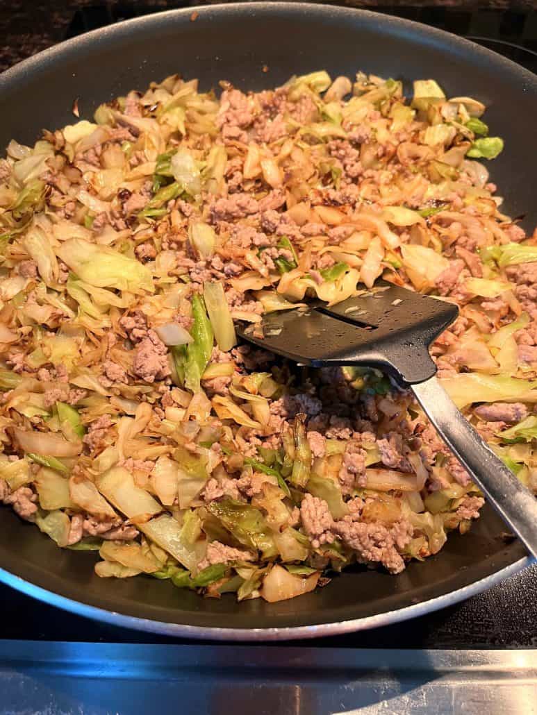 A pan filled with sautéed cabbage and browned ground turkey, showcasing a completed low-carb and healthy dish from the Ground Turkey and Cabbage recipe.