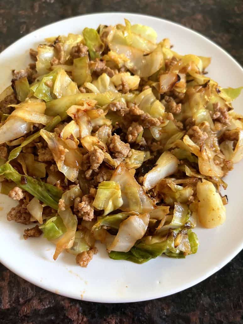 A plate of sautéed cabbage and ground turkey served as a healthy and low-carb meal.