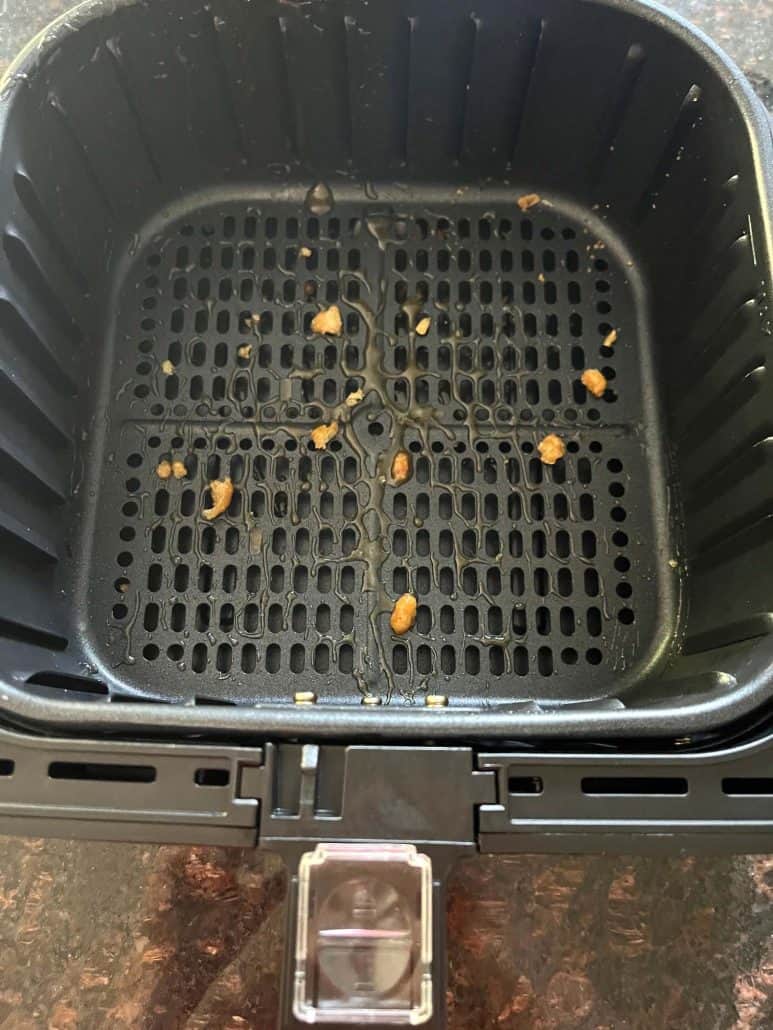 Top view of dirty air fryer basket.