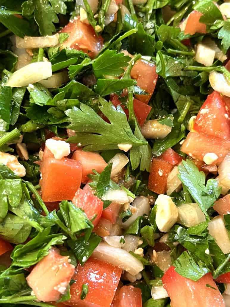 Close-up of a parsley salad, showcasing the fresh ingredients described in the recipe.