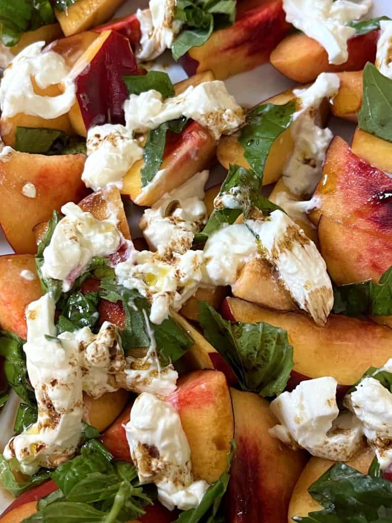 Top view close-up of peach burrata salad.