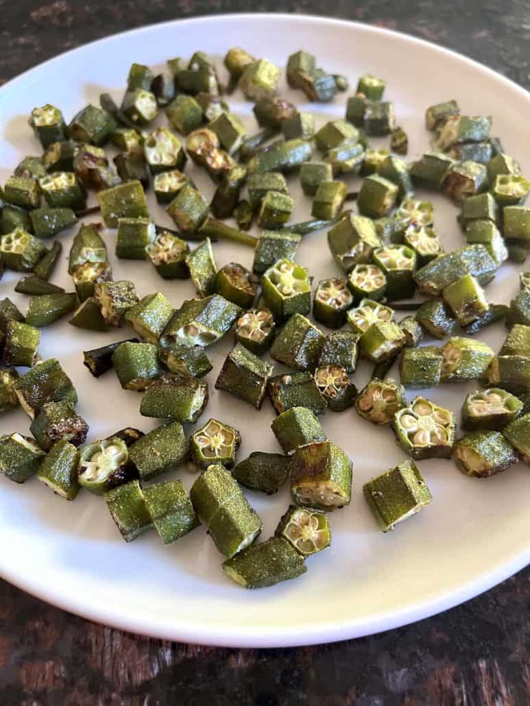 Crispy roasted okra pieces served on a white plate.