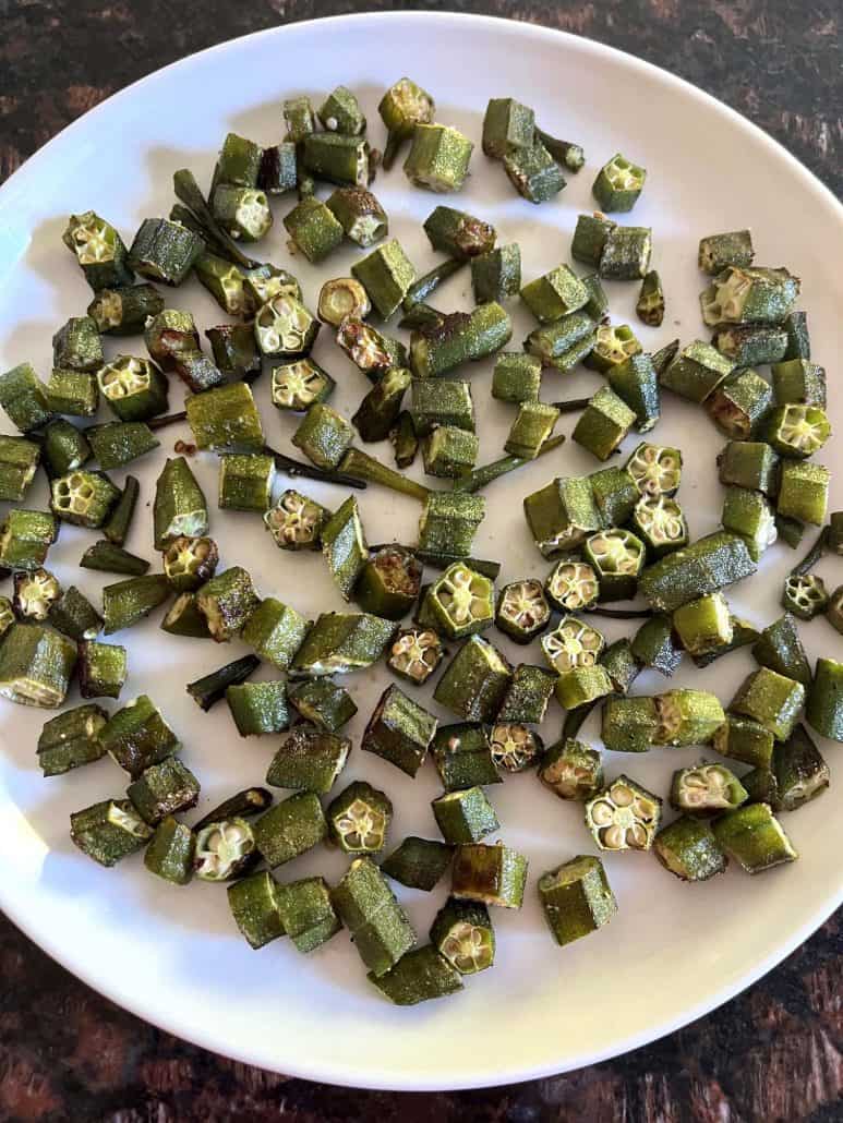 A plate of roasted okra pieces with crispy edges, evenly browned and ready to serve.