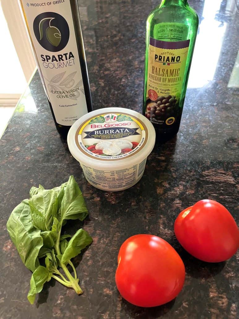 The five ingredients of a tomato burrata salad.