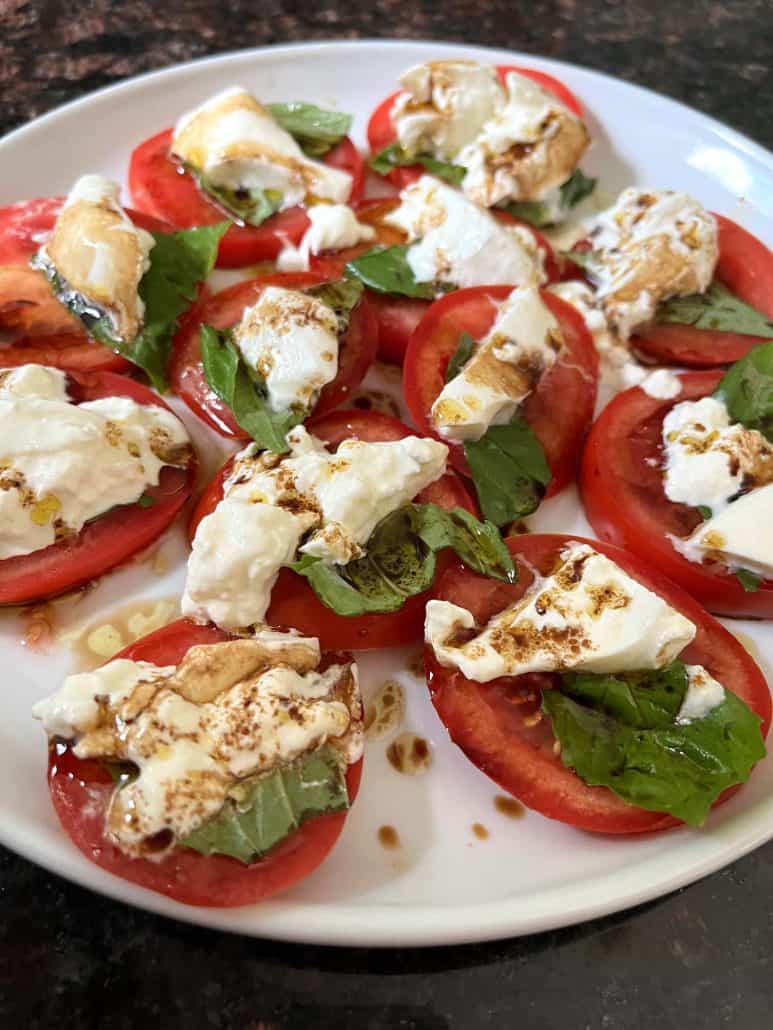 A detailed view of a tomato burrata salad.