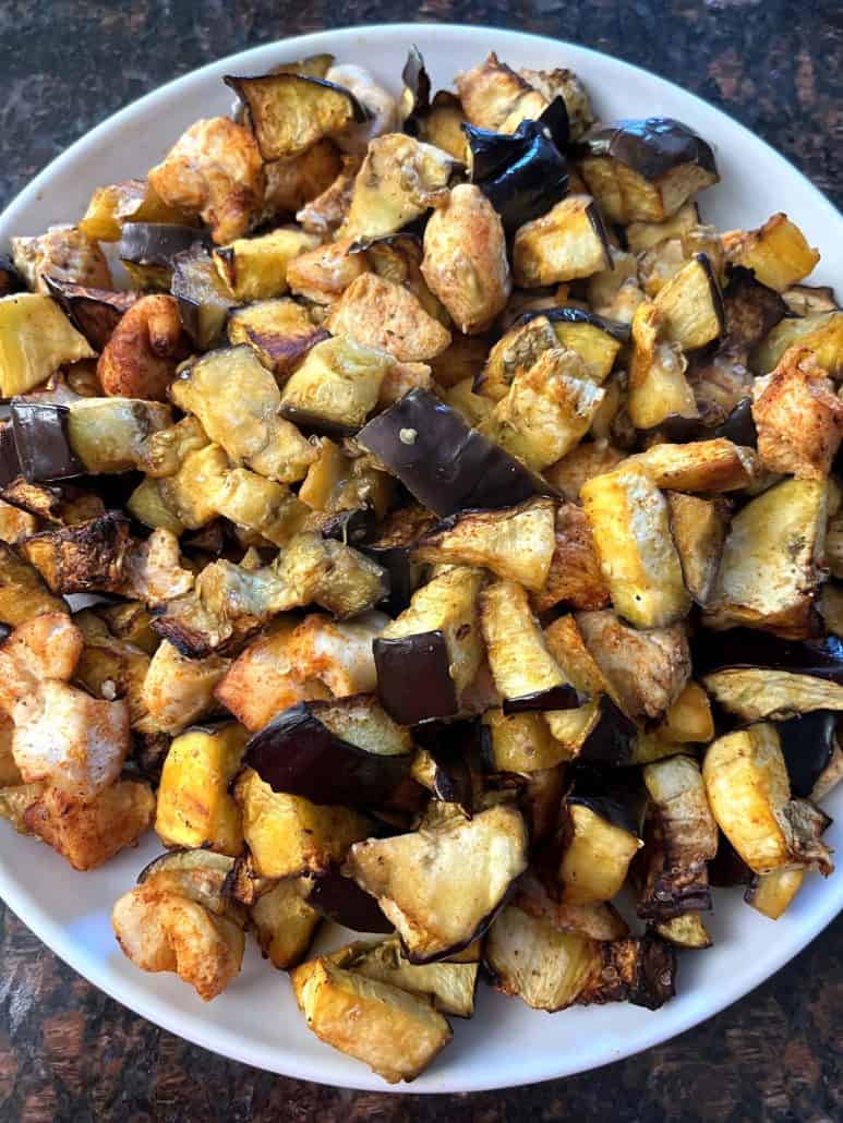 A plate filled with air-fried chicken and eggplant.