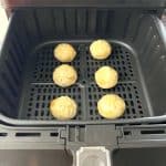 Golden brown dumplings perfectly cooked in an air fryer basket, demonstrating the easy and effective air frying method for frozen Bibigo dumplings.