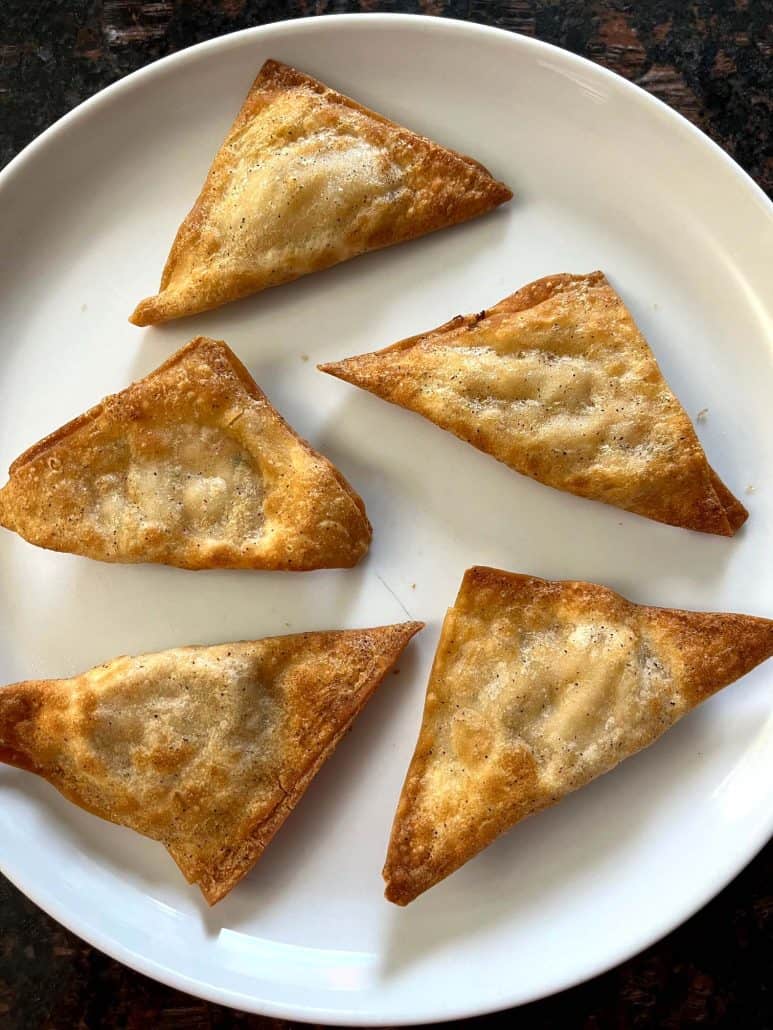 Five golden, crispy Buffalo Style Chicken Poppers served on a white plate, ready to eat.