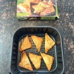 Crispy Buffalo Style Chicken Poppers freshly cooked in an air fryer basket with the packaging box displayed above, showing the finished result.