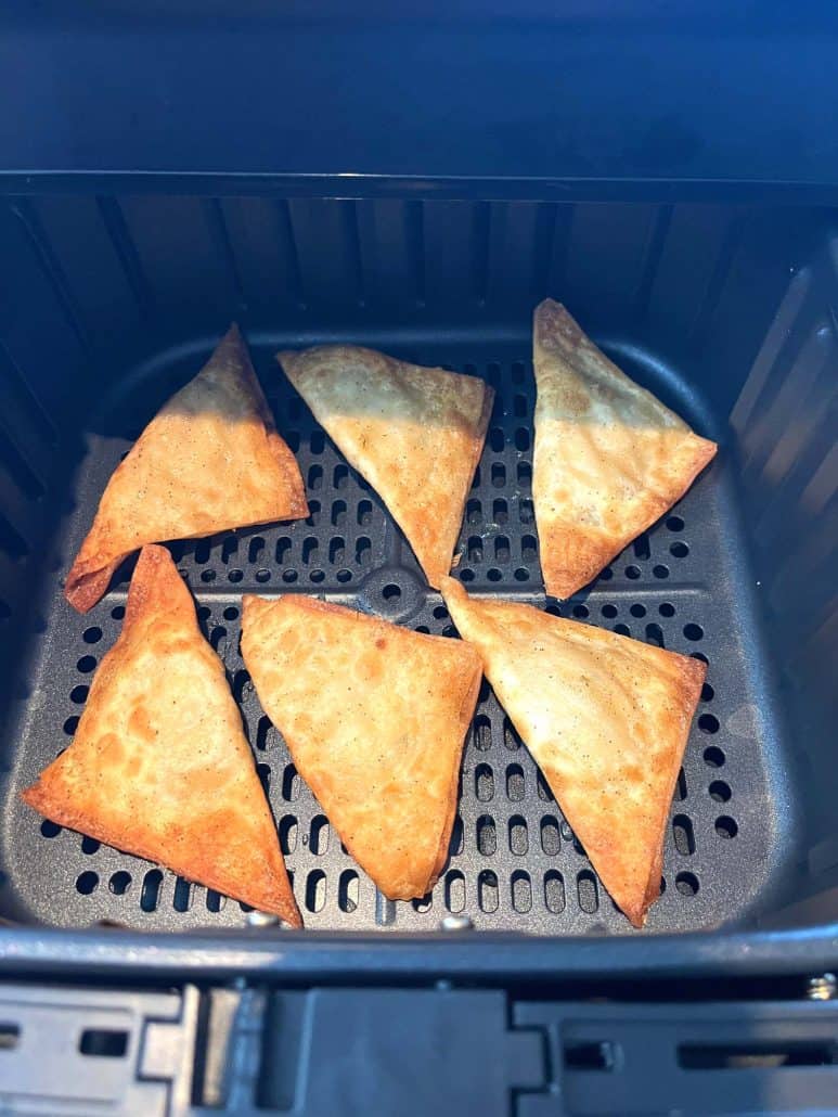 Close-up of golden, crispy Buffalo Style Chicken Poppers in an air fryer basket.