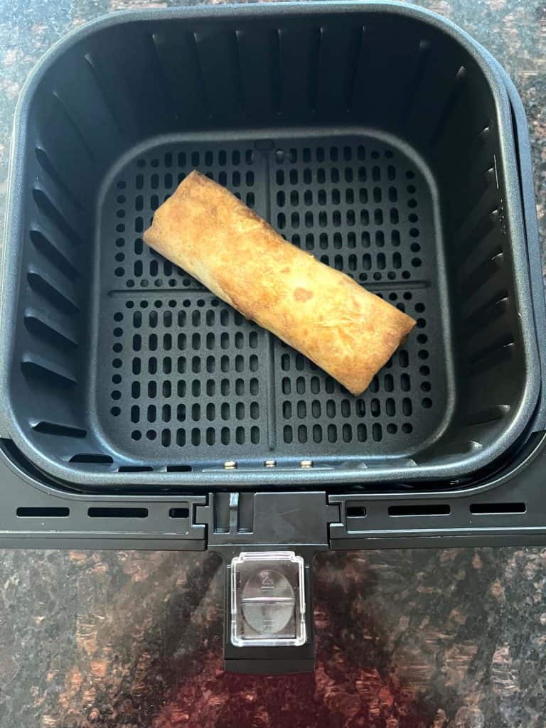 Freshly air-fried Kati roll in the air fryer basket.