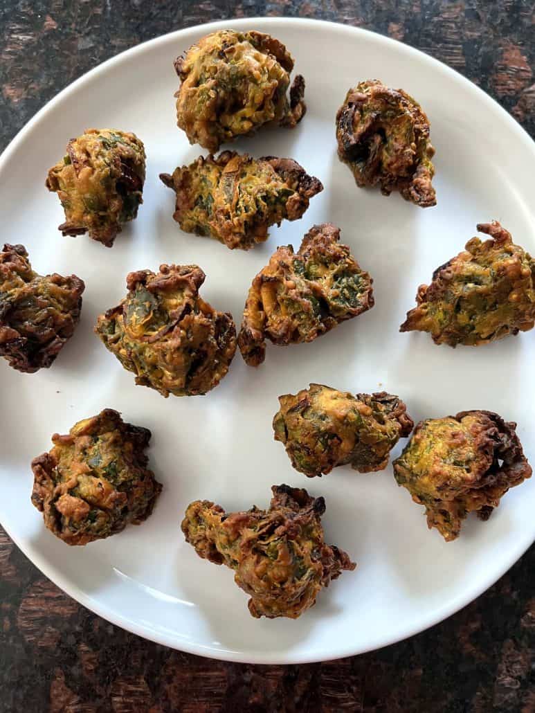 Ready to serve crispy, golden-brown pakoras, as a tasty snack or appetizer.