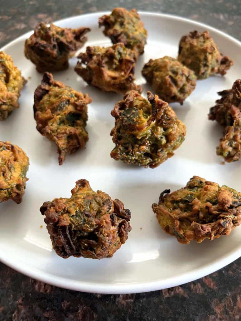 Freshly air-fried pakoras on a plate, showcasing it's crispy texture.