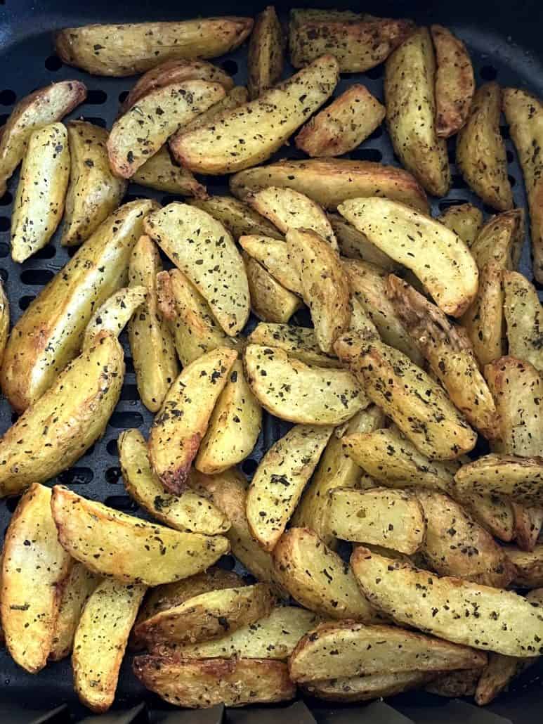 Close-up view of crispy, golden air-fried potato wedges.