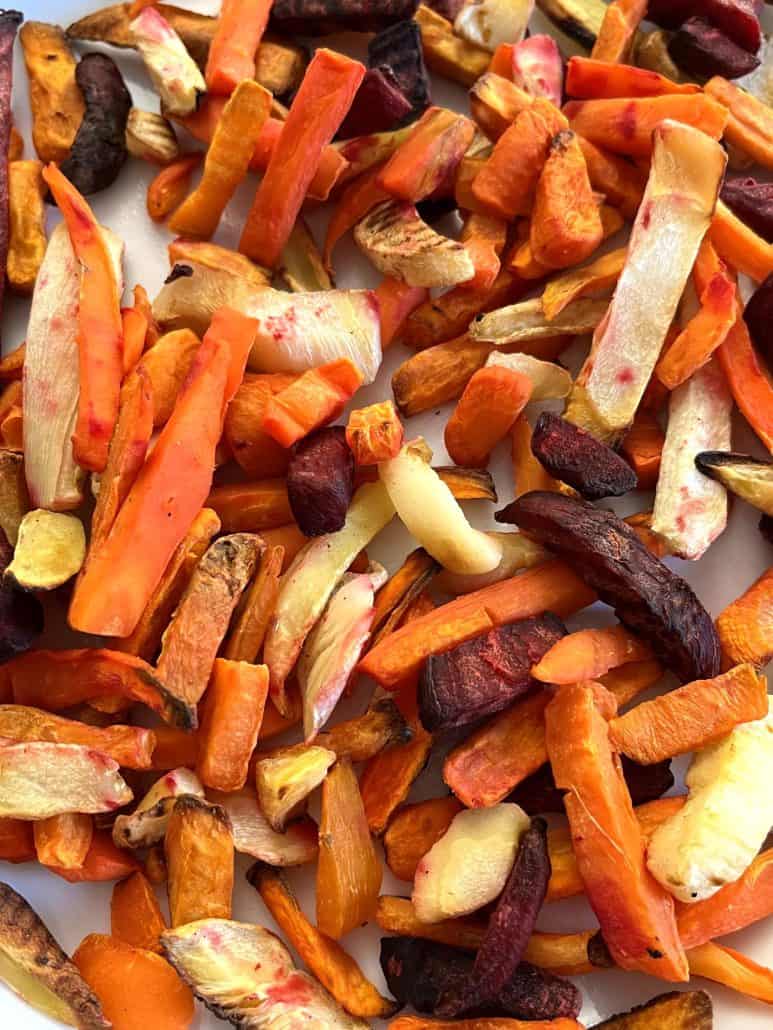 Close-up of colorful frozen root vegetable fries, including sweet potatoes, carrots, beets, and parsnips, ready for air frying.