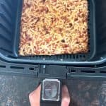 Crispy Totino’s Party Pizza freshly cooked in an air fryer basket.