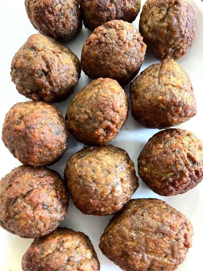 Close-up of a plate filled with crispy, golden-brown air-fried Impossible Meatballs.