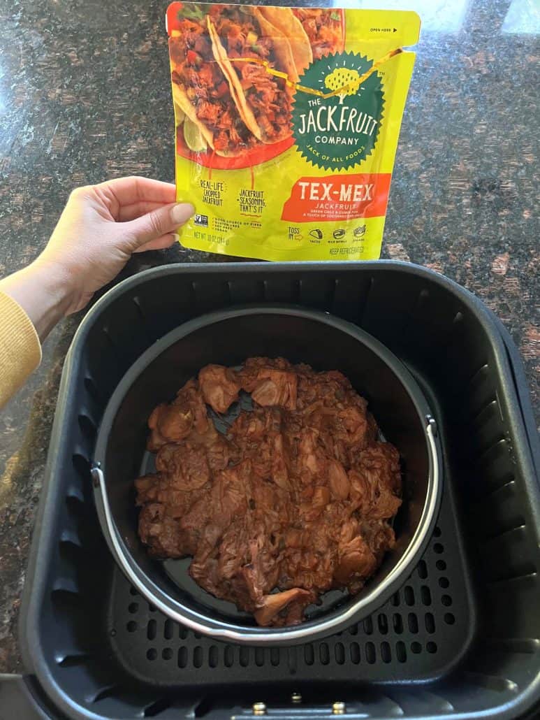 Cooked Tex-Mex jackfruit in a pan inside the air fryer basket.