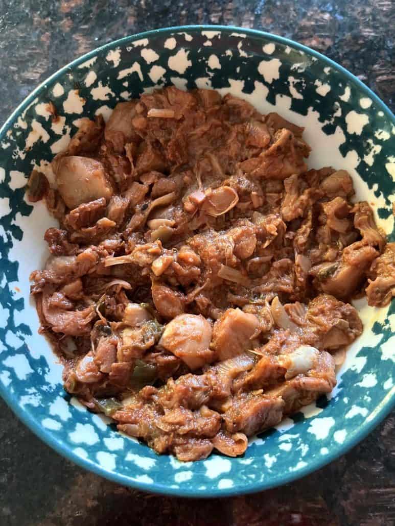 Top view of a bowl filled with shredded, meat-like texture Tex-Mex jackfruit.