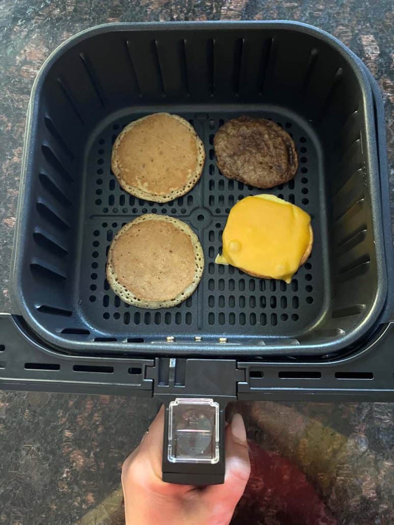 Air fryer basket with cooked Jimmy Dean Maple Griddle Cake.