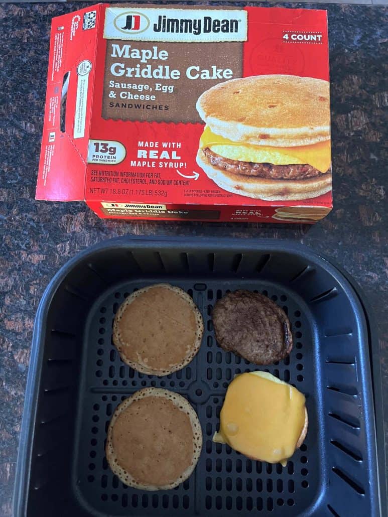 Air fryer basket with cooked Jimmy Dean Maple Griddle Cake sandwich.