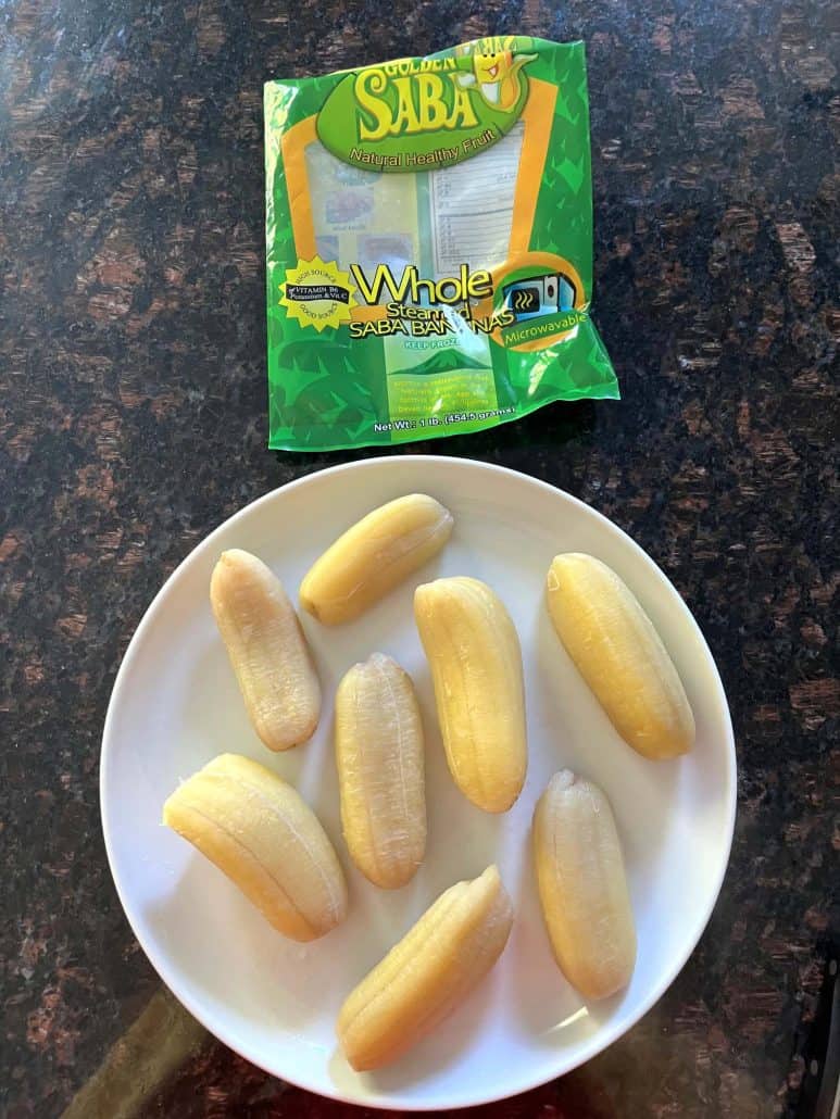 Boiled Saba bananas served on a white plate with the packaging of frozen Saba bananas.