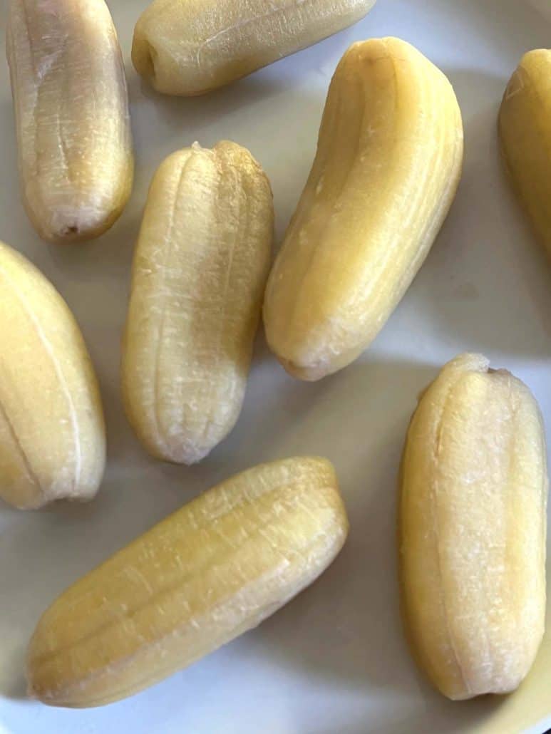 Close-up of boiled Saba bananas on a white plate.